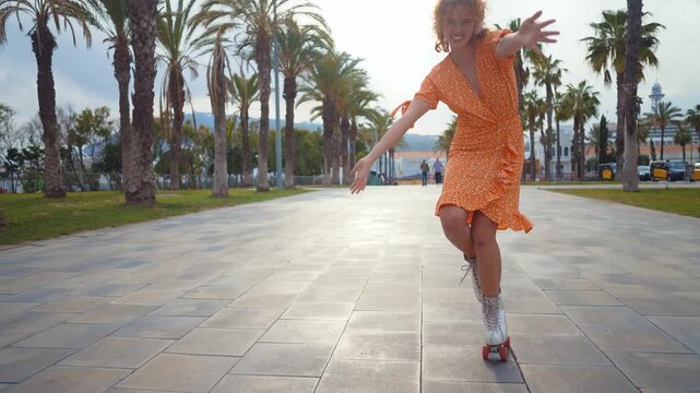 Beautiful red haired young woman with rollerskates having fun outdoors