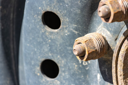 Quebec, Canada, 27 April 2026 : Close-up view of rusty lug nuts on a vehicle wheel hub, showing corrosion and wear