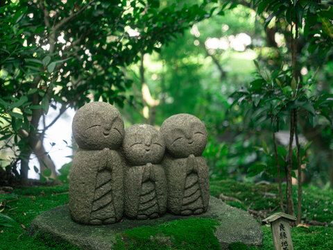 Three Jizo Stone Statues in a Mossy Garden