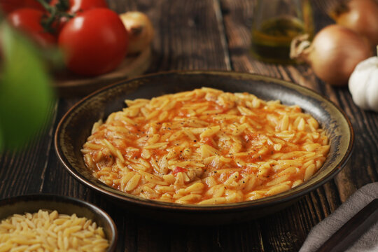 A bowl with traditional Greek soup Manestra with orzo pasta