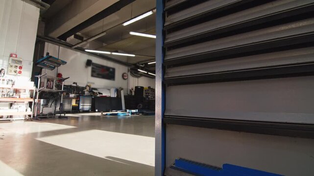 Professional car repair service's interior, spacious workshop with clean, organised bays and hydraulic lifts for vehicle access.
