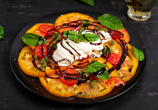 Gourmet Tomato and Burrata Salad on Dark Background