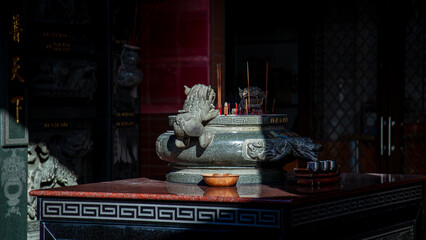Stone-carved incense burners for the Jade Emperor in traditional Taiwanese temples and the swaying incense smoke used for daily prayers. © paul