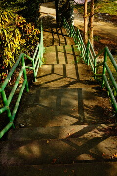 Sunlit Concrete Steps With Strong Railing Shadows Outdoors