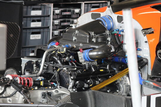 View of a high-performance racing car engine with carbon fiber air intake and mechanical components at Donington Park Circuit in Castle Donington, England, United Kingdom.