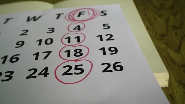 Close up of a calendar page with circled dates indicating a weekly schedule.