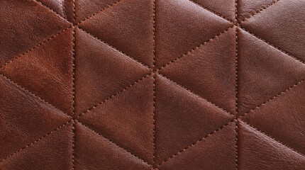 Naklejka premium Quilted leather surface with geometric sections, showcasing fine grain and rich topaz color, evokes sense of luxury and craftsmanship