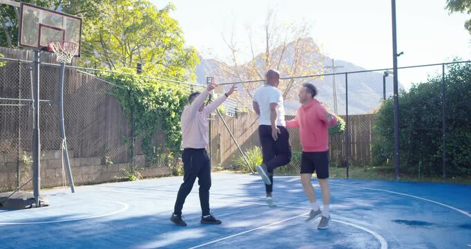 Diverse men playing basketball on home court white tee driving defenders bumping sitting for fun