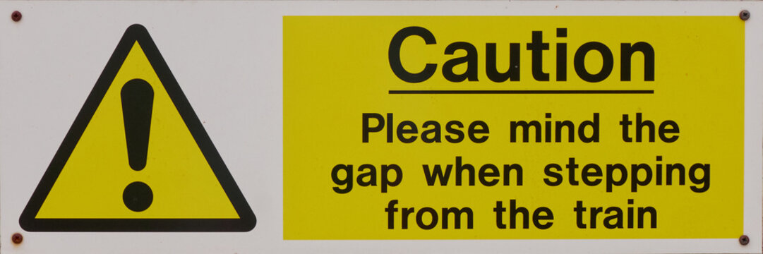 Railway sign, Caution. Please mind the gap when stepping from the train. Modern in bright white, yellow and black with bold, graphic design