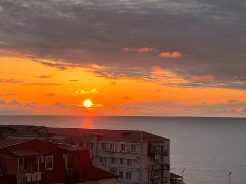 Glowing sun touching the horizon of the Black Sea at sunset.
