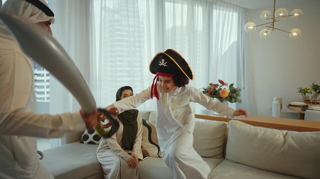 Emirati family playing with son wearing pirate costume