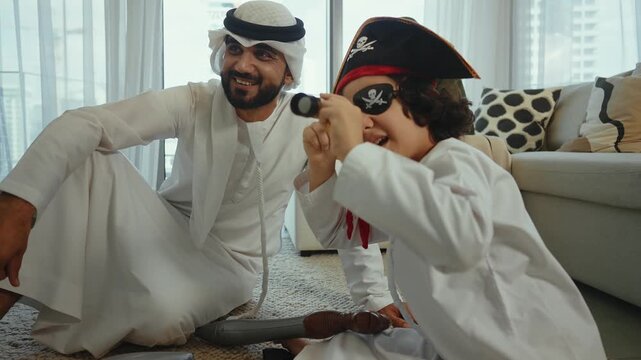 Emirati family playing with son wearing pirate costume