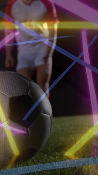 Animation of neon shapes over caucasian football player kicking ball at stadium