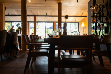 Elegant restaurant interior with cozy seating and warm lighting. A table served for celebration or wine party at a bar or restaurant. © Mykola