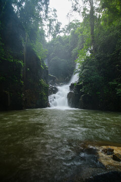 Tranquil Mountain River Flowing Through Dense Forestes and Cliffs