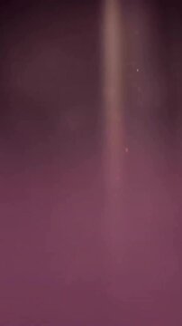 Animation of glowing light spots moving over black background