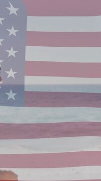 American flag animation over couple embracing and looking at ocean