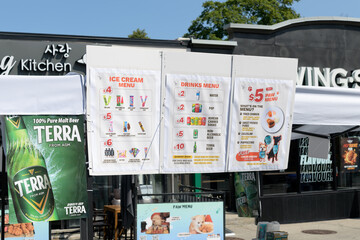 Fototapeta premium exterior buildings and paper menu posters outside Sarang Kitchen located at 774 Danforth Av, Toronto
