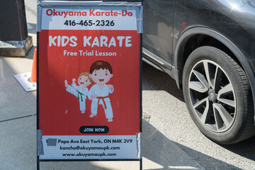 Fototapeta premium a-frame sidewalk sign outside Okuyama Karate Dō, a martial arts school, located at 983 Pape Av, East York, Toronto