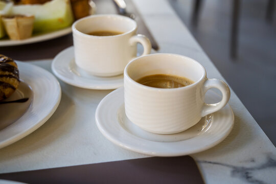 Two cups of coffee on a breakfast table, cafe travel holiday and leisure background