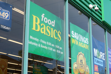 Fototapeta premium exterior window display with signs at Food Basics, a discount supermarket chain, located here at 1070 Pape Av, East York, Toronto