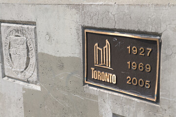 Fototapeta premium old Metropolitan Toronto stone and new bronze metal plaques on the Leaside Bridge