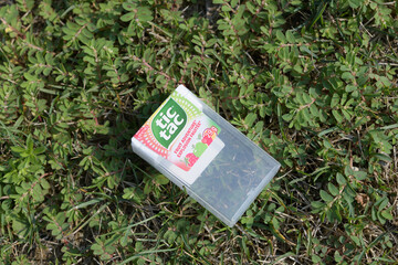 Fototapeta premium discarded empty plastic box of tic tac fruit flavors made by Ferreo on the ground in Toronto