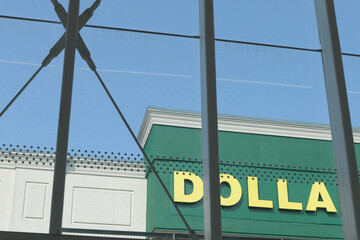 Fototapeta premium detail, sign of Dollarama, a dollar store chain, viewed from Laird station, and located at 815 Eglinton Av E, RioCan, Leaside, Toronto