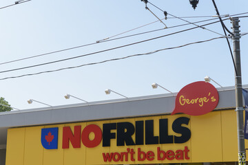 Fototapeta premium exterior building facade and sign of George's NOFRILLS, a grocery store chain, located at 720 Broadview Av, Toronto