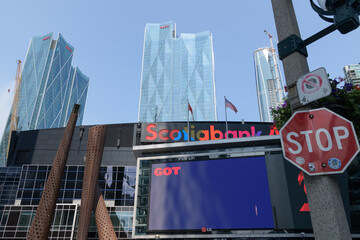 Fototapeta premium stop sign outside Scotiabank Arena (Maple Leaf Square entrance) with view of CIBC Square towers, Toronto