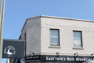Fototapeta premium exterior building and sign of Goat Coffee Co, a cafe, located at 893 Pape Av (East York), Toronto