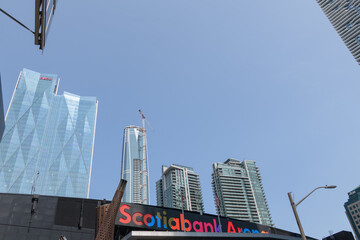 Fototapeta premium view of sign over entrance to Scotiabank Arena from Maple Leaf Square incl view of office towers and mixed-use condominium complexes in Toronto