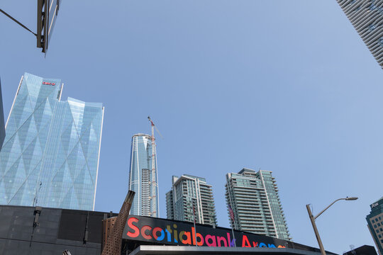 view of sign over entrance to Scotiabank Arena from Maple Leaf Square incl view of office towers and mixed-use condominium complexes in Toronto