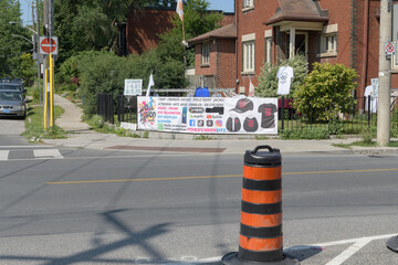 Fototapeta premium wide distant view of a t-shirt seller at Browning Av and Pape Av, Toronto