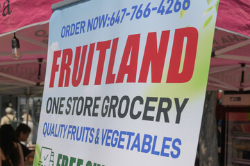 Fototapeta premium poster sign outside Fruitland, a supermarket, located at 458 Danforth Av, Toronto