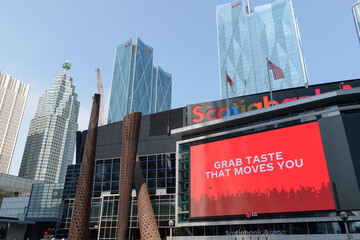 Fototapeta premium looking north from Maple Leaf Square outside Scotiabank Arena with digital billboard featuring an advertisement for Coke Studio, Toronto