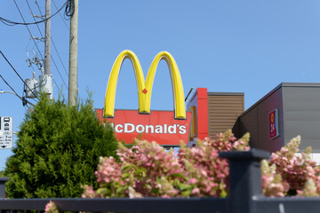 Fototapeta premium Golden Arches sign outside a McDonald's Canada fast food restaurant location at 1045 Pape Av E (East York), Toronto