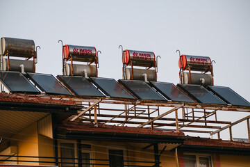 Manavgat, Antalya Province, Turkey, July 26, 2026: Rooftop solar water heating systems on a residential building © Inga