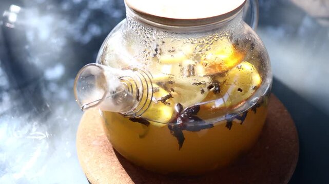 A pitcher filled with liquid sits on a wooden plate, perfect for serving drinks or as a decorative piece