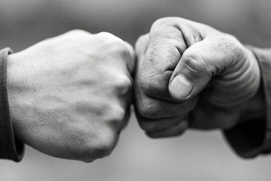 Fist bump gesture of two hands showing unity teamwork agreement and cooperation