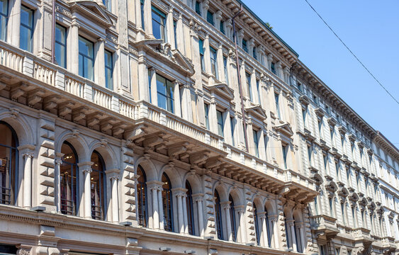 Milan house wall Ornate Classical Architecture Facade with Arched Windows and Columns in Milan street Center City Italy.