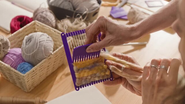 Women practicing weaving on small hand loom during creative craft workshop. Clip is ideal for DIY tutorial videos, hobby school advertisements, or creative therapy campaigns
