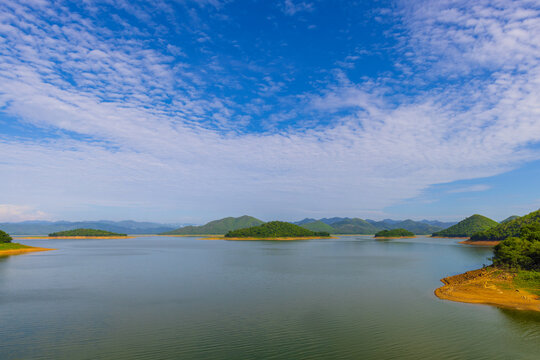 Kaeng Krachan Dam Scenic View of Lake and Mountains,Wide-angle scenic view of Kaeng Krachan Dam in Thailand, featuring numerous small, lush green islands scattered across the vast, calm turquoise.