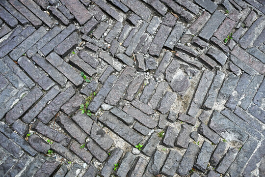 Weathered stone paving with imperfections and irregular geometric pattern