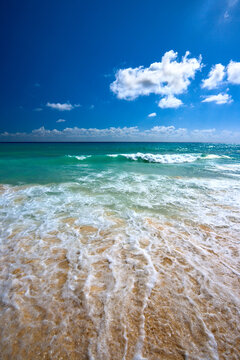 Scene featuring beautiful beach and waves of Caribean Sea