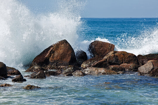 A waves breaking against the rocks