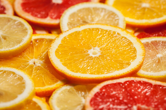 A colorful citrus fruit - lemon, orange, grapefruit - slices background, with fashion