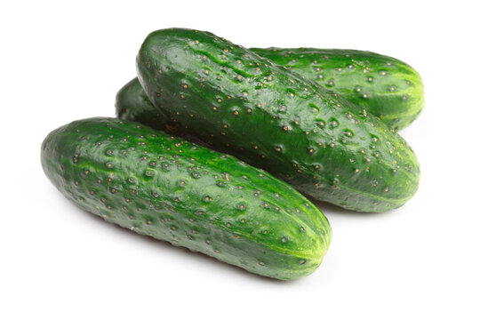 Scene featuring three green cucumbers isolated on white background