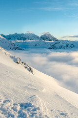 Winter mountain sunset landscape above clouds in Zakopane, Kasprowy wierh, Poland. © Alena Malinouskaya