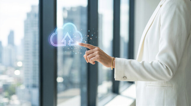 Businesswoman touching a digital cloud upload icon in a modern office with a city skyline view, representing cloud computing and data storage